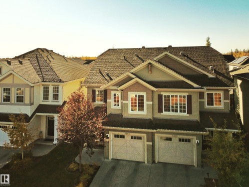 The property features a two-story design with a multi-toned exterior and a dark shingle roof - 6888 Evans Wynd, Edmonton, AB -  With Facade