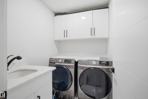 Laundry area featuring white cabinetry, a sink with a black faucet, and a light-colored countertop - 2420 13 Avenue, Edmonton, AB - Indoor Photo Showing Laundry Room