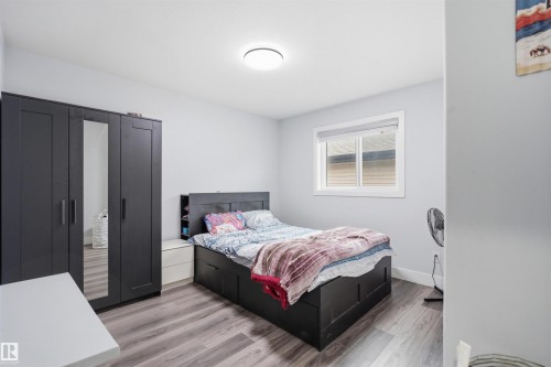 This room features light-colored walls and wood-look flooring - 2420 13 Avenue, Edmonton, AB - Indoor Photo Showing Bedroom
