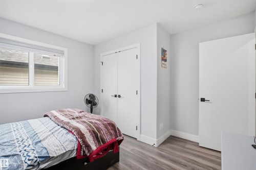 This room features a window with white trim, light-colored walls, and wood-look flooring - 2420 13 Avenue, Edmonton, AB - Indoor Photo Showing Bedroom