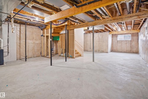 The property features an unfinished lower level with concrete flooring, exposed wooden beams, and a visible window - 2420 13 Avenue, Edmonton, AB - Indoor Photo Showing Basement