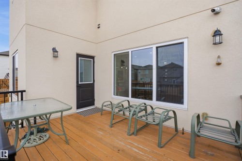 The property features an outdoor deck with wooden flooring, a window, and a door leading to the interior - 2420 13 Avenue, Edmonton, AB - Outdoor With Deck Patio Veranda With Exterior