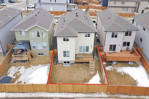 The property features a private backyard with a wooden fence and a raised wooden deck - 2420 13 Avenue, Edmonton, AB - Outdoor