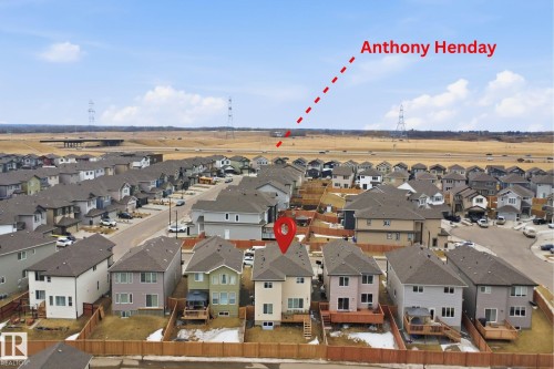 The property is situated within a developed residential community, offering convenient access to a major roadway visible in the distance - 2420 13 Avenue, Edmonton, AB - Outdoor With View
