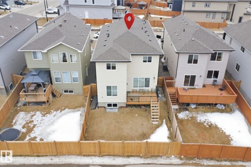 The property features a fenced backyard with a raised wooden deck and stairs - 2420 13 Avenue, Edmonton, AB - Outdoor