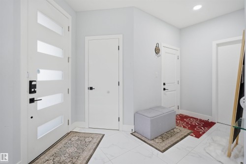 Entryway featuring light-colored walls, white doors, and white tile flooring - 2420 13 Avenue, Edmonton, AB - Indoor Photo Showing Other Room