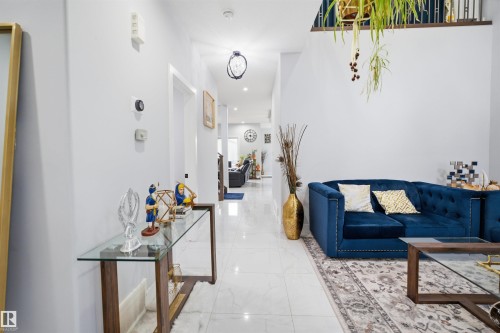 The property features a hallway with light-colored walls and flooring, leading into other areas - 2420 13 Avenue, Edmonton, AB - Indoor