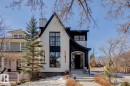 The property's distinctive exterior features a striking black and white facade with an arched entryway and large windows - 11146 62 Street Nw, Edmonton, AB  - Outdoor With Facade 