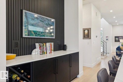 Integrated custom cabinetry with a built-in wine rack and a white countertop - 11146 62 Street Nw, Edmonton, AB - Indoor