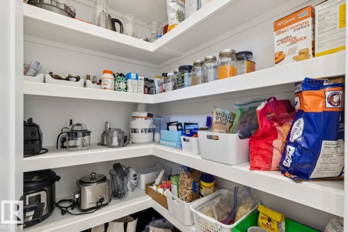 Spacious pantry with extensive white shelving, providing ample storage - 11146 62 Street Nw, Edmonton, AB - Indoor
