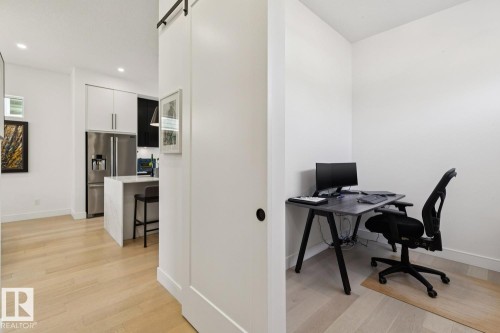 The property offers a dedicated office space with light hardwood flooring - 11146 62 Street Nw, Edmonton, AB - Indoor Photo Showing Office