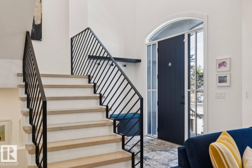 The property features an entryway with a dark-colored door, an arched transom window, and tall sidelight windows - 11146 62 Street Nw, Edmonton, AB -  Photo Showing Other Room