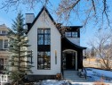 This property presents a striking exterior with a white facade and contrasting black accents, featuring a prominent peaked roofline - 11146 62 Street Nw, Edmonton, AB  - Outdoor 