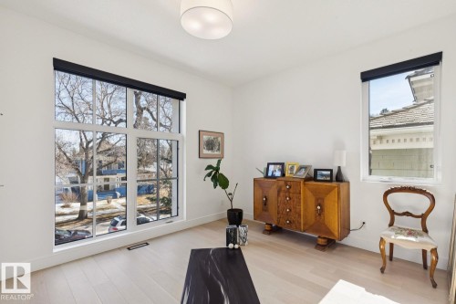 This room features light-colored wood flooring, white walls, and a recessed ceiling light - 11146 62 Street Nw, Edmonton, AB - Indoor