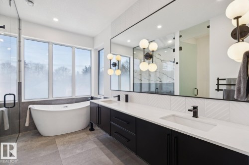Bathroom featuring a freestanding soaking tub, a large vanity with double sinks, and a spacious glass-enclosed shower - 11146 62 Street Nw, Edmonton, AB - Indoor Photo Showing Bathroom