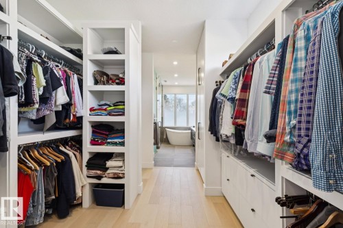 The property features a spacious walk-in closet with extensive custom shelving and hanging storage - 11146 62 Street Nw, Edmonton, AB - Indoor With Storage