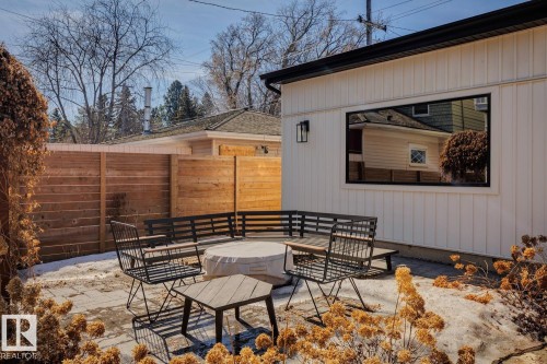 A private outdoor patio space with a fire pit, surrounded by a wooden fence - 11146 62 Street Nw, Edmonton, AB - Outdoor