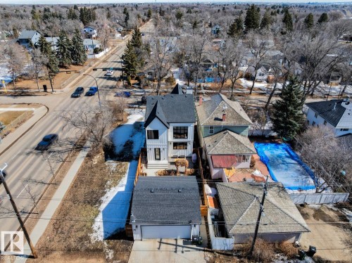 The property features a two-story home with a dark-pitched roof and a white exterior, a detached garage with a dark-pitched roof, and a paved driveway - 11146 62 Street Nw, Edmonton, AB - Outdoor With View