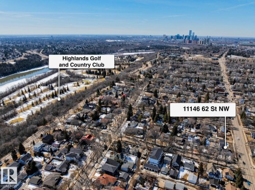 Aerial view of the property's community, featuring views of Highlands Golf and Country Club, a river, and a city skyline in the distance - 11146 62 Street Nw, Edmonton, AB - Outdoor With View