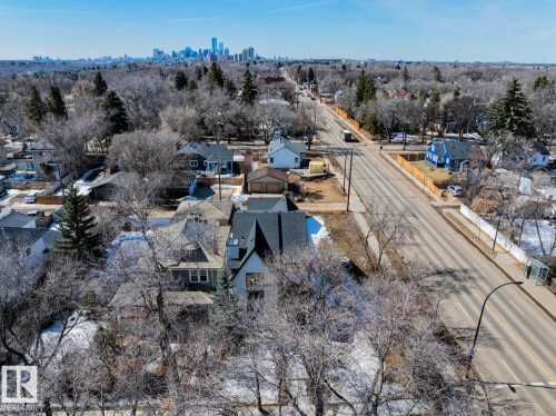 Aerial view showcasing the property within a residential neighborhood featuring mature trees and a prominent street - 11146 62 Street Nw, Edmonton, AB - Outdoor With View
