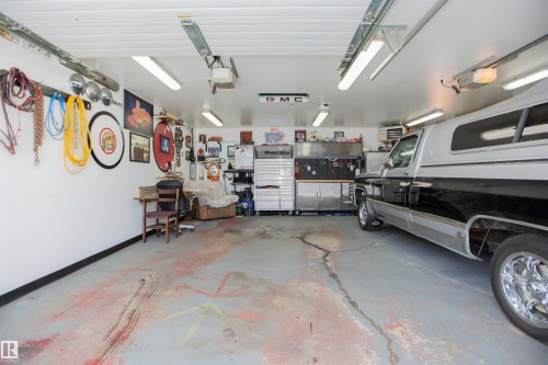 Spacious garage with overhead lighting and a workbench area - 12827 109 Street, Edmonton, AB - Indoor Photo Showing Garage