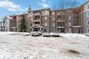The property features an exterior with stone and siding finishes, private balconies, and a covered entrance - 319 17415 99 Avenue, Edmonton, AB  - Outdoor With Facade 