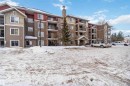 The property is a multi-story building featuring a facade of mixed materials including siding and stone accents - 319 17415 99 Avenue, Edmonton, AB  - Outdoor With Facade 