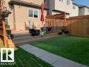 The property features a wooden deck with railing, a lawn, and a paved walkway - 1536 21 Street, Edmonton, AB  - Outdoor With Exterior 