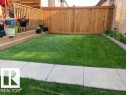 The property features a well-maintained lawn and a wooden fence providing privacy - 1536 21 Street, Edmonton, AB  - Outdoor 