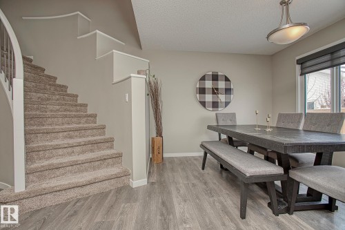 This inviting dining area features light-toned flooring and a window with a dark roller blind - 7718 Eifert Crescent, Edmonton, AB - Indoor Photo Showing Dining Room