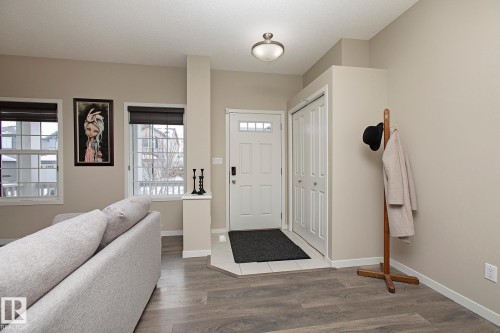 The property features a welcoming entryway with a white door and an adjacent closet with bi-fold doors - 7718 Eifert Crescent, Edmonton, AB - Indoor Photo Showing Other Room