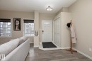 The property features a welcoming entryway with a white door and an adjacent closet with bi-fold doors - 7718 Eifert Crescent, Edmonton, AB  - Indoor Photo Showing Other Room 
