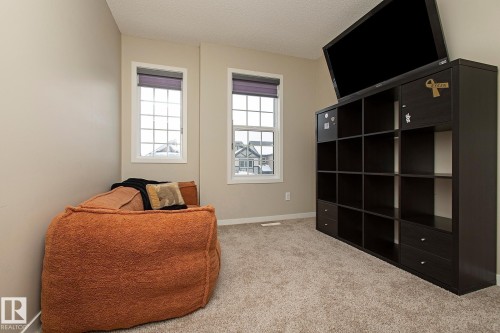 This room features two windows with window blinds, light-colored walls, and carpeting - 7718 Eifert Crescent, Edmonton, AB - Indoor Photo Showing Bedroom