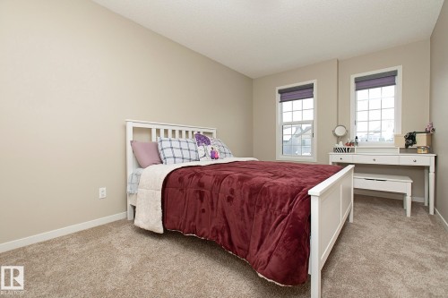 Bedroom featuring carpeted flooring and two windows with blinds - 7718 Eifert Crescent, Edmonton, AB - Indoor Photo Showing Bedroom