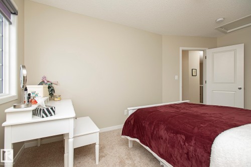 Bedroom featuring neutral toned walls, carpeted floors, and a window providing natural light - 7718 Eifert Crescent, Edmonton, AB - Indoor Photo Showing Bedroom