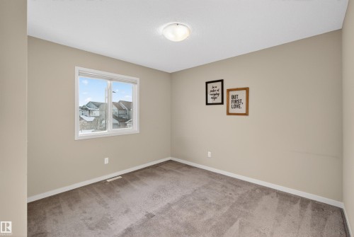 Bright room featuring a window providing natural light, neutral painted walls, and carpeted flooring - 4723 Alwood Bend, Edmonton, AB - Indoor Photo Showing Other Room