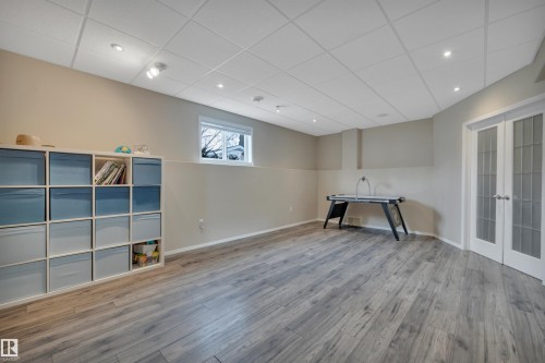 This expansive room features light-toned walls, recessed lighting, and durable plank flooring - 5 Parkview Crescent, Calmar, AB - Indoor