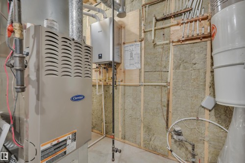The property features a Carrier heating and cooling system and a Rinnai tankless water heater - 5 Parkview Crescent, Calmar, AB - Indoor Photo Showing Basement