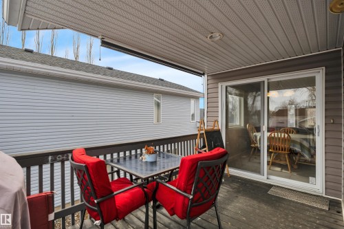 The property features a covered deck with a sliding glass door for outdoor access - 5 Parkview Crescent, Calmar, AB - Outdoor With Deck Patio Veranda With Exterior