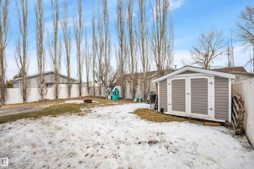 The property features a spacious yard with a storage shed and a white fence - 5 Parkview Crescent, Calmar, AB - Outdoor