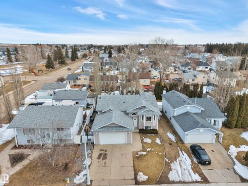 The property features a grey-shingled roof, an attached two-car garage, and a light-colored exterior - 5 Parkview Crescent, Calmar, AB - Outdoor With View