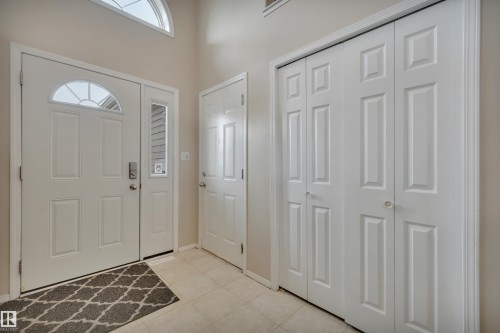 Entryway featuring a white paneled door with an arched window, a side window, and a transom window above - 5 Parkview Crescent, Calmar, AB - Indoor Photo Showing Other Room