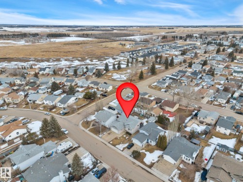 Aerial view showcasing the property situated within a residential neighborhood featuring homes with grey roofs and driveways - 5 Parkview Crescent, Calmar, AB - Outdoor With View