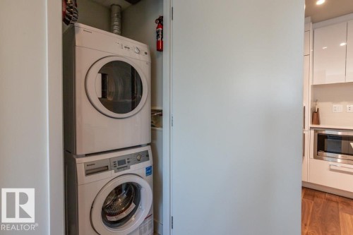 The property features a stacked washer and dryer for convenience - 2506 10360 102 Street, Edmonton, AB - Indoor Photo Showing Laundry Room