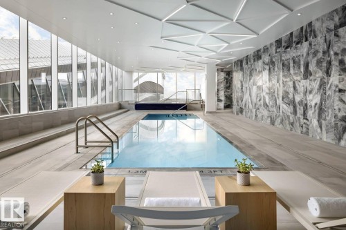 Indoor swimming pool featuring an integrated hot tub and large windows - 2506 10360 102 Street, Edmonton, AB - Indoor Photo Showing Other Room With In Ground Pool