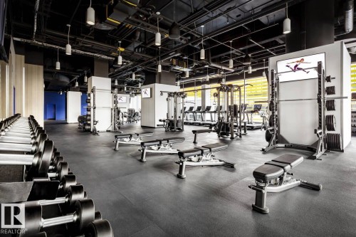 The property features a well-equipped fitness center with various exercise machines, free weights, and weight benches - 2506 10360 102 Street, Edmonton, AB - Indoor Photo Showing Gym Room
