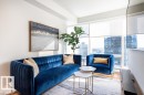 This living area features expansive windows with city views - 2506 10360 102 Street, Edmonton, AB  - Indoor Photo Showing Living Room 