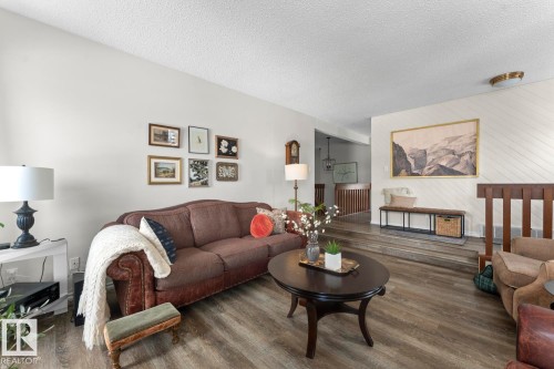 The living room features wood-look flooring and light-colored walls - 4003 50A Avenue, Cold Lake, AB - Indoor Photo Showing Living Room