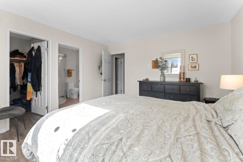 The property features a bright bedroom with light-colored walls and wood-look flooring - 4003 50A Avenue, Cold Lake, AB - Indoor Photo Showing Bedroom