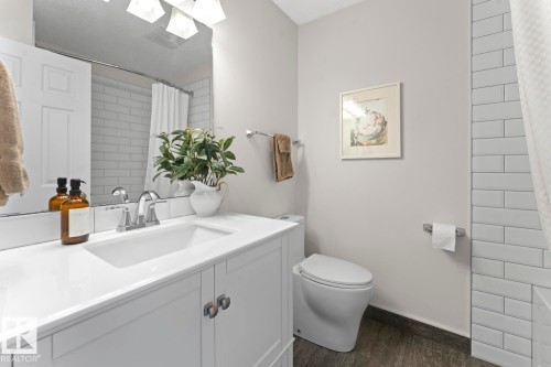 The bathroom features a white vanity with a rectangular sink, a polished chrome faucet, and a large mirror - 4003 50A Avenue, Cold Lake, AB - Indoor Photo Showing Bathroom